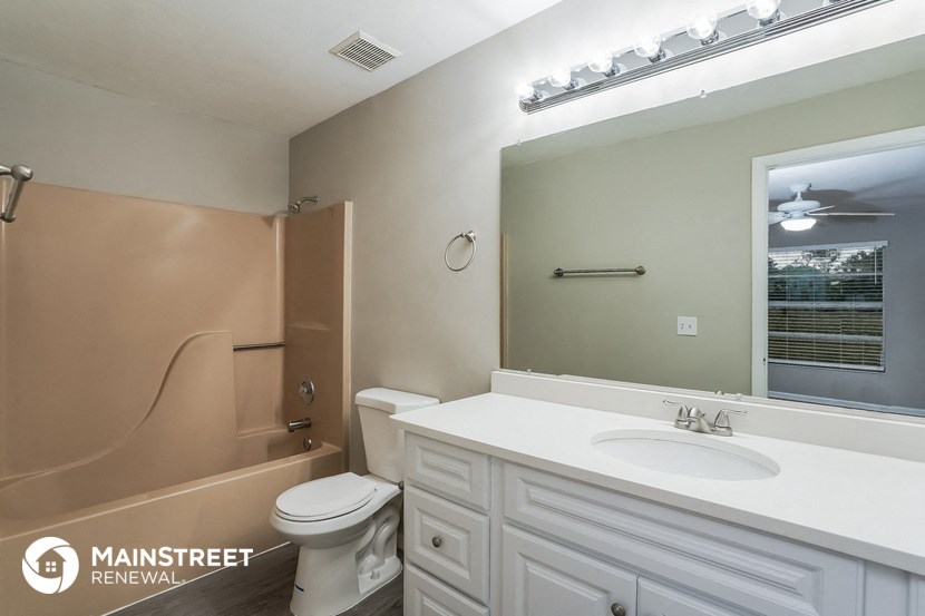 a bathroom with a sink and a toilet and a bath tub