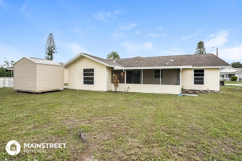 the front of a house with a yard and a garage