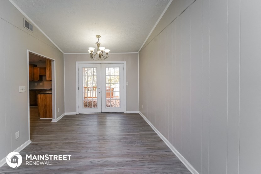the living room of a new home with white walls and wood floors