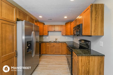 a kitchen with wooden cabinets and stainless steel appliances
