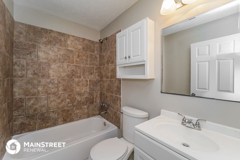 a bathroom with a sink toilet and a bath tub