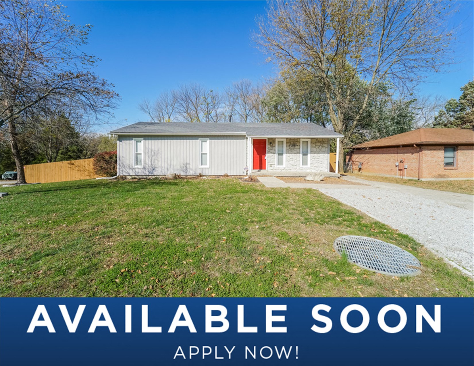 a small white house with a yard and a driveway