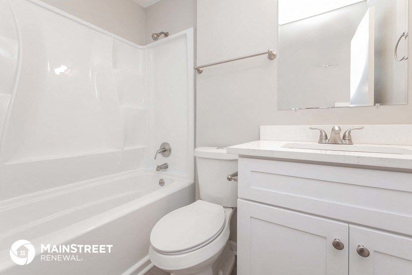 a white bathroom with a sink toilet and tub