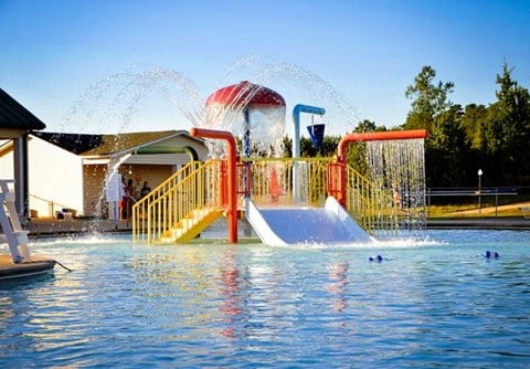 a water park with a swimming pool and a water slide