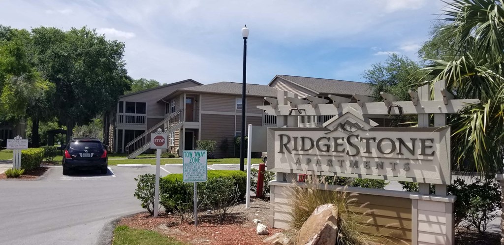 a sign for the ridgestone neighborhood in front of a house