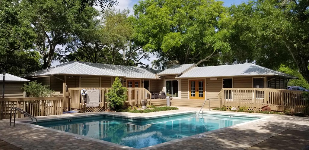 a house with a swimming pool in front of it
