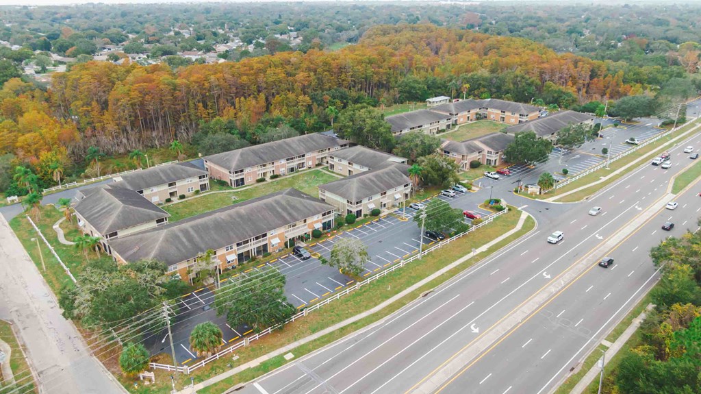 an aerial view of a building next to a highway