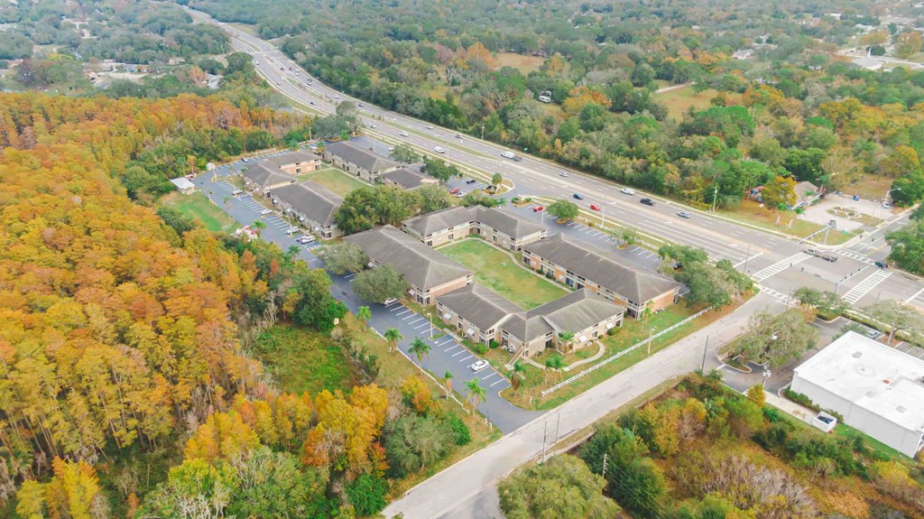 an aerial view of a parking lot next to a highway