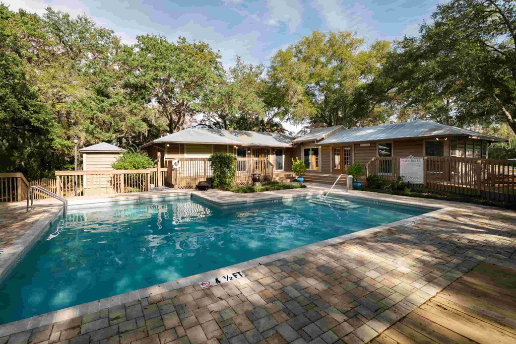 a swimming pool with a house in the background