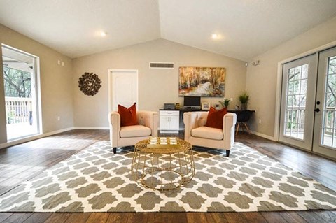 a living room with two chairs and a table