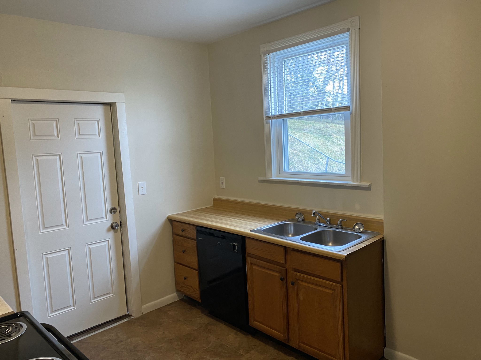 a small kitchen with a sink and a window