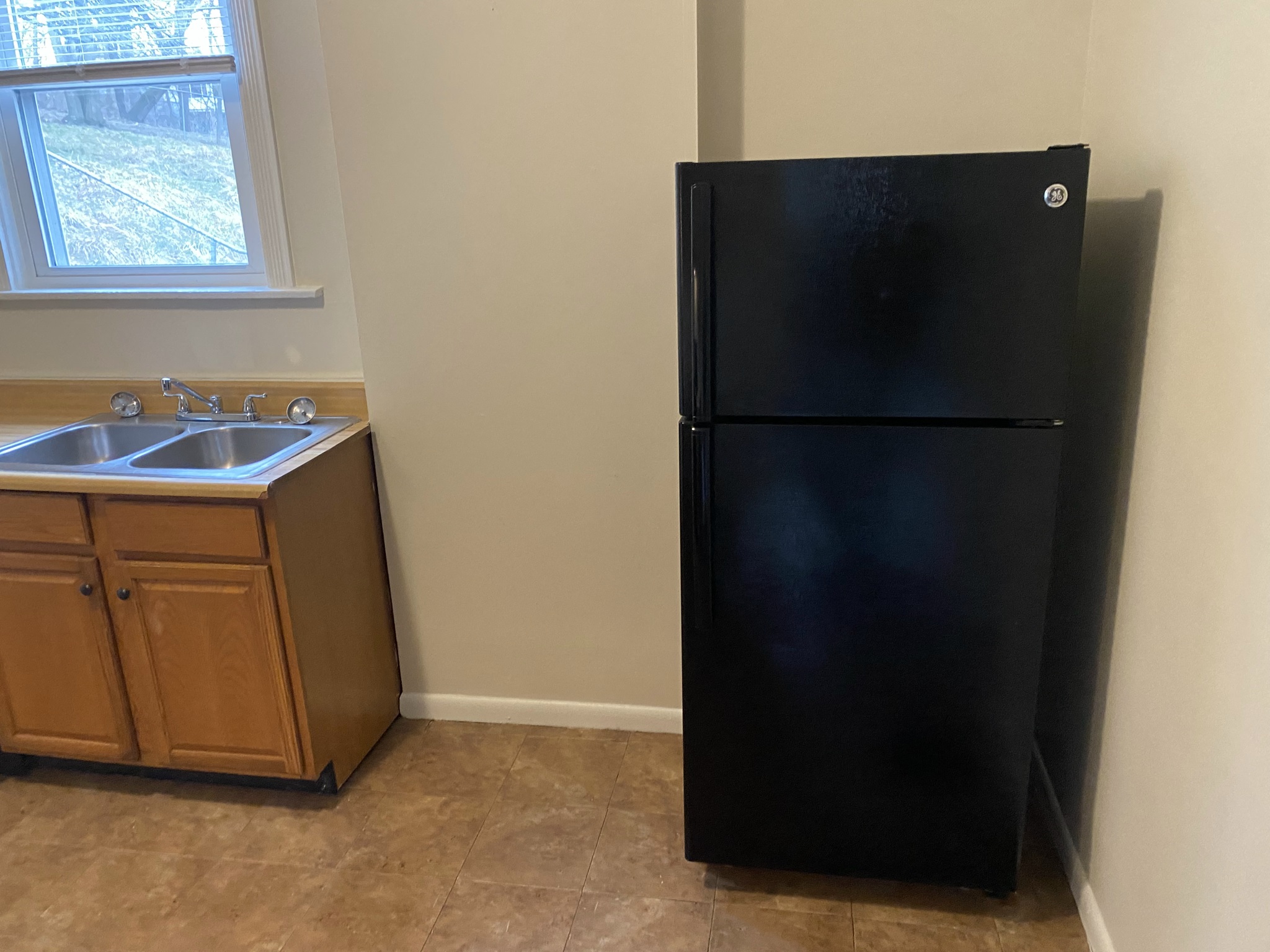 a kitchen with a refrigerator and a sink