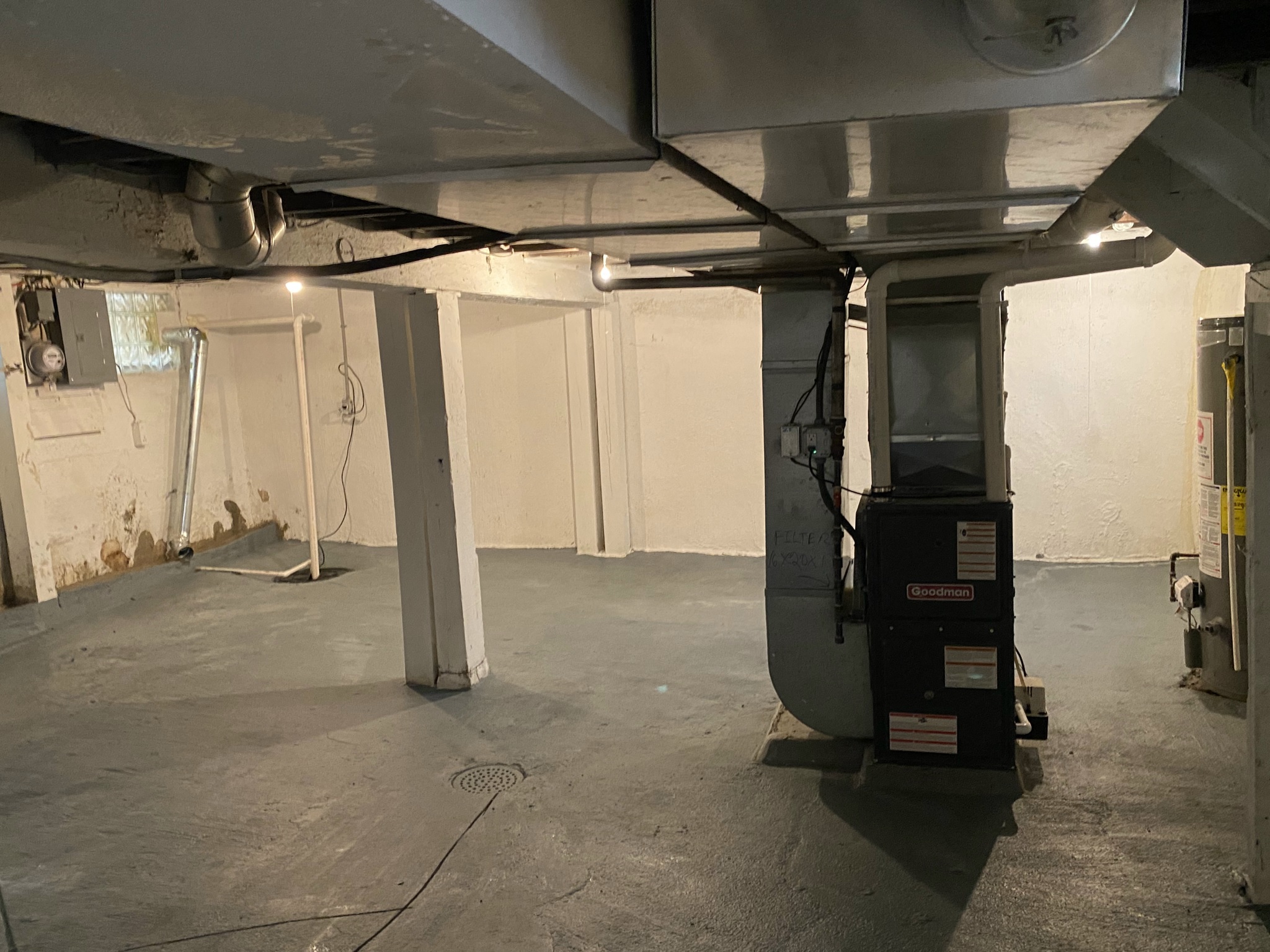the unfinished basement of a building with a car wash machine