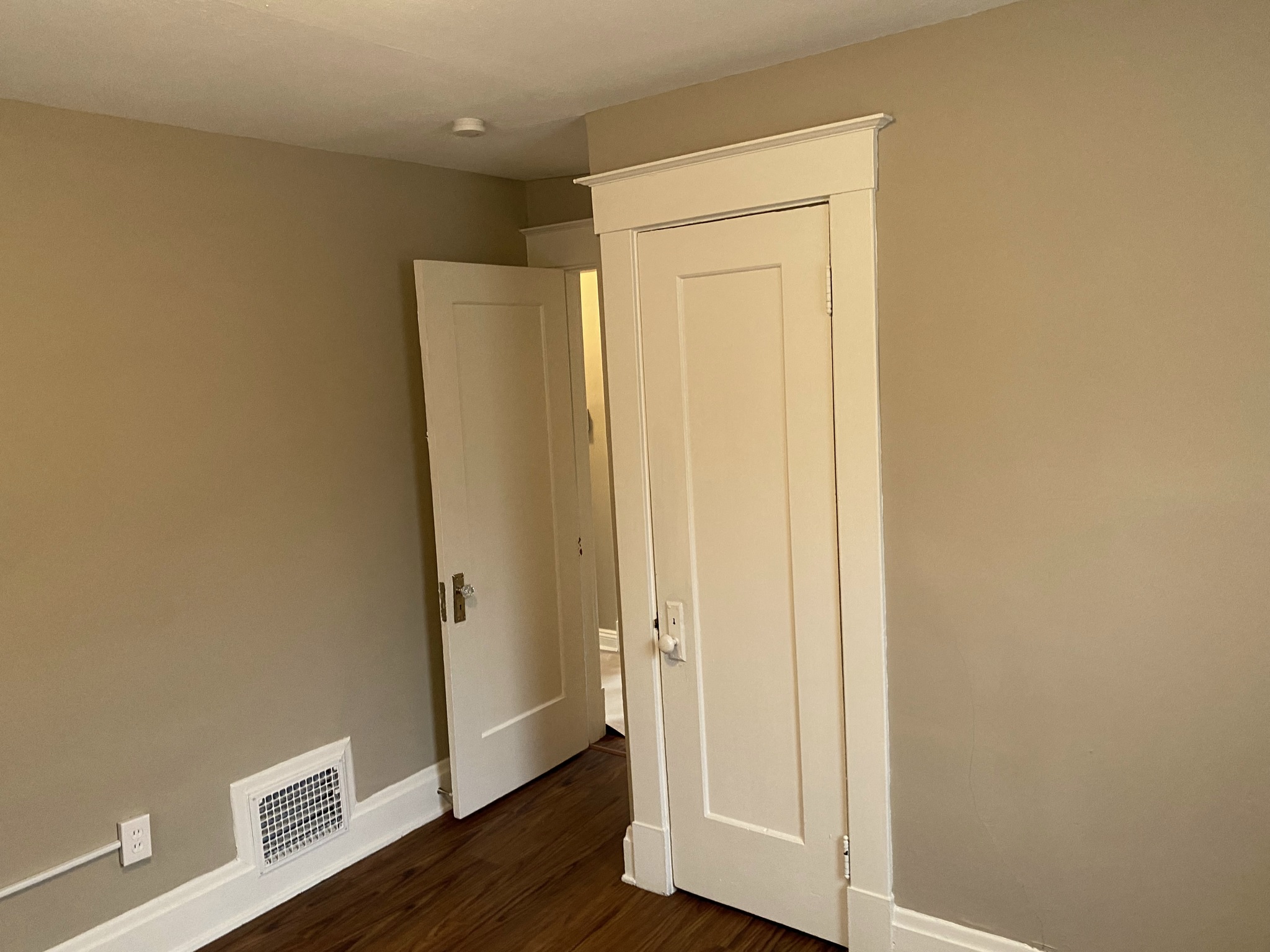 a bedroom with two closets and a door to a hallway