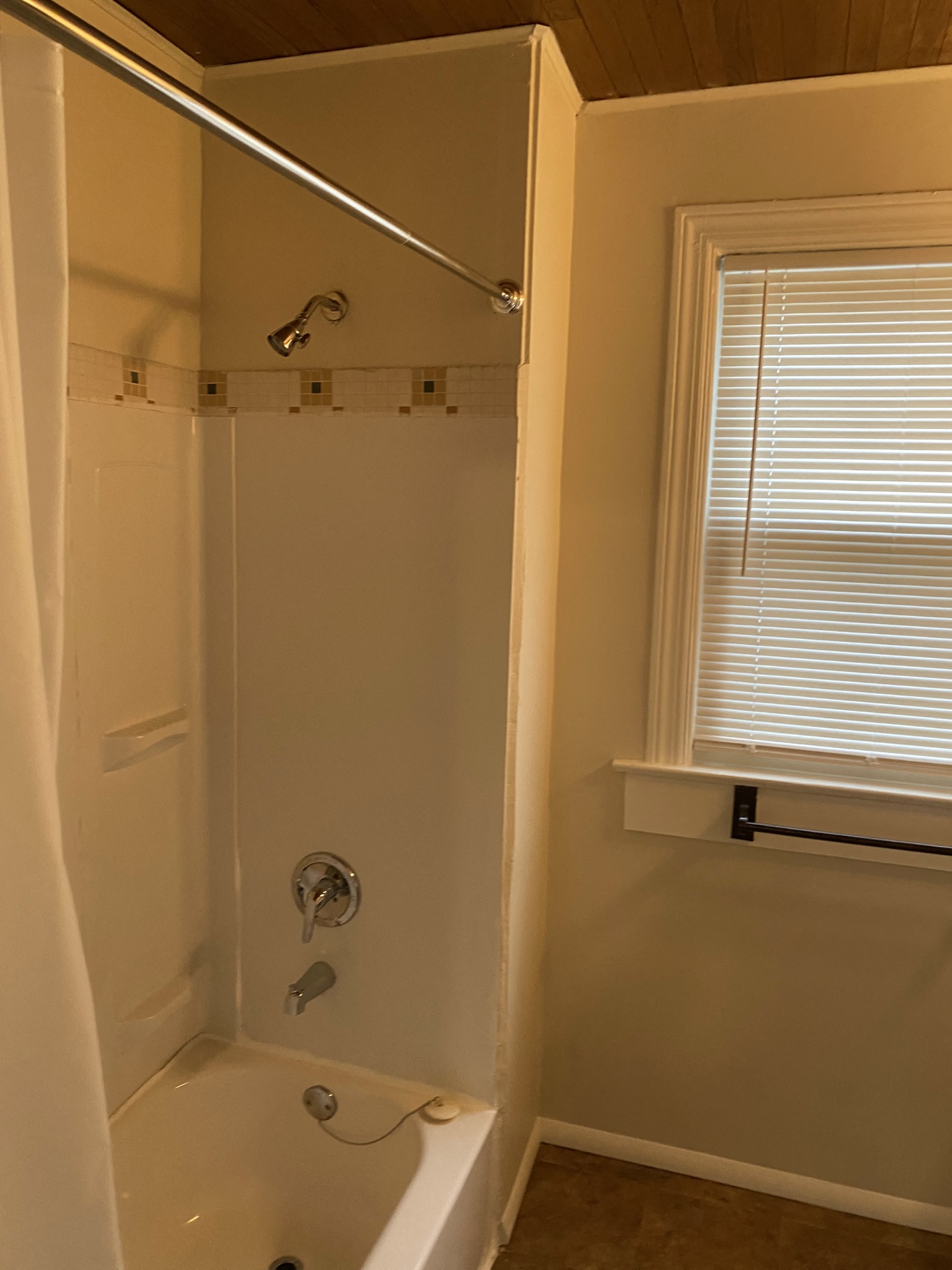 a small bathroom with a shower and a tub