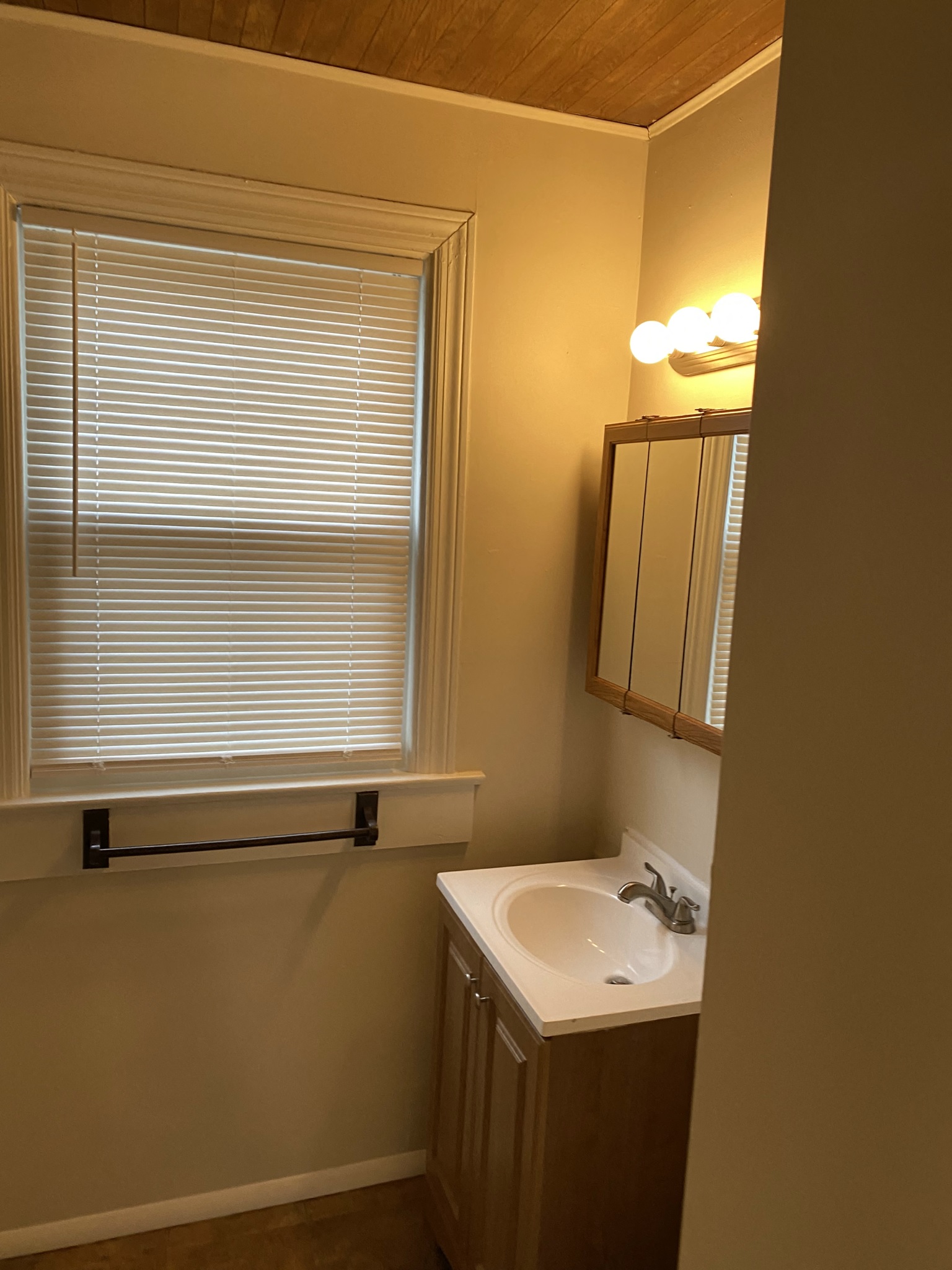 a small bathroom with a sink and a window