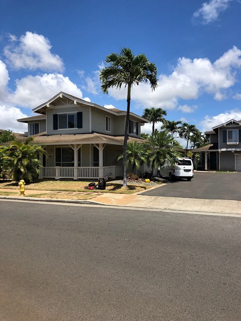 A house with a white van parked in front.