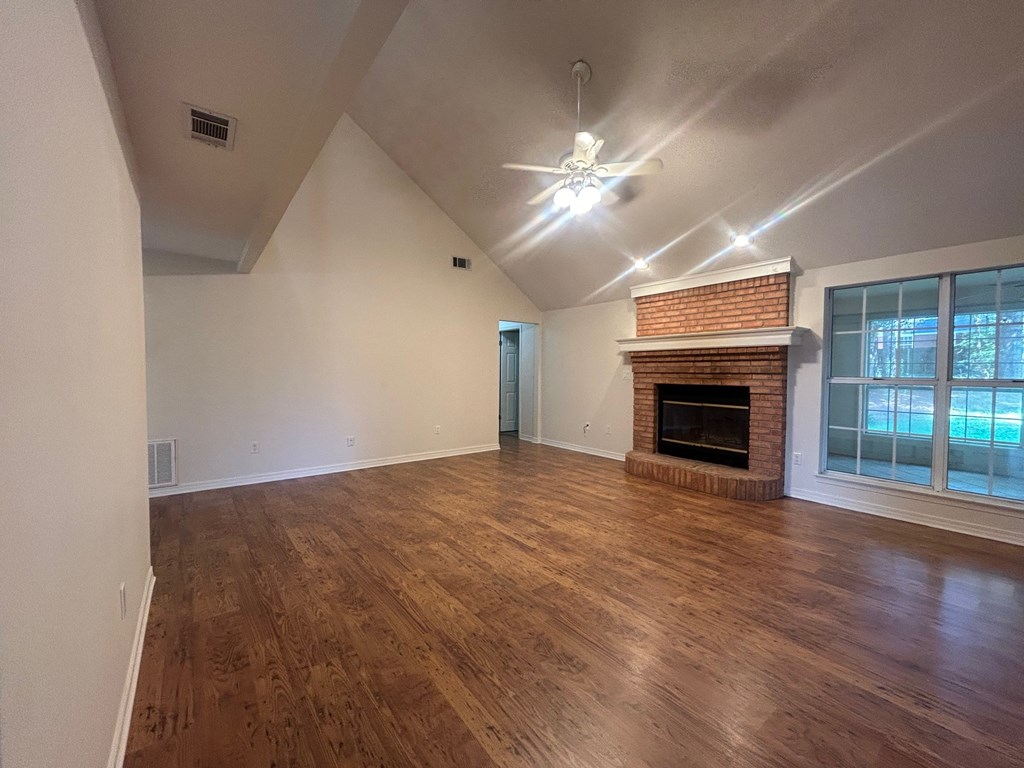 A room with wooden floors and a fireplace.
