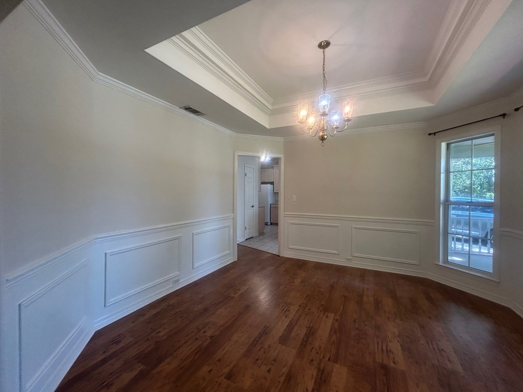 A room with wooden floors and white walls.
