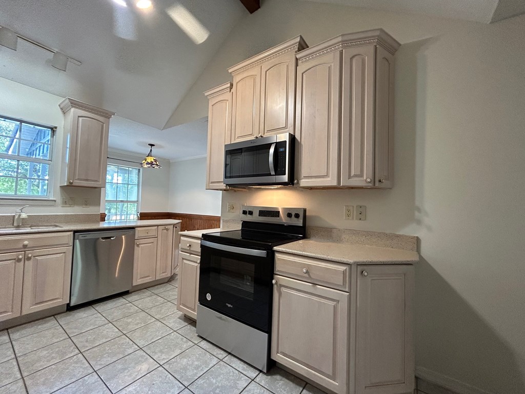 A kitchen with a stove top oven and microwave.