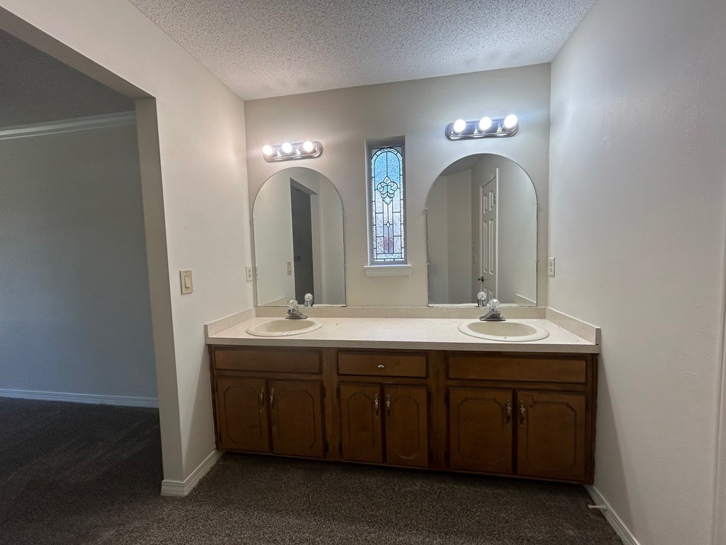 A bathroom with two sinks and two mirrors.