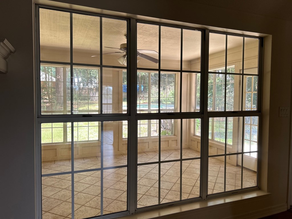 A view through a glass door into a tiled patio area.