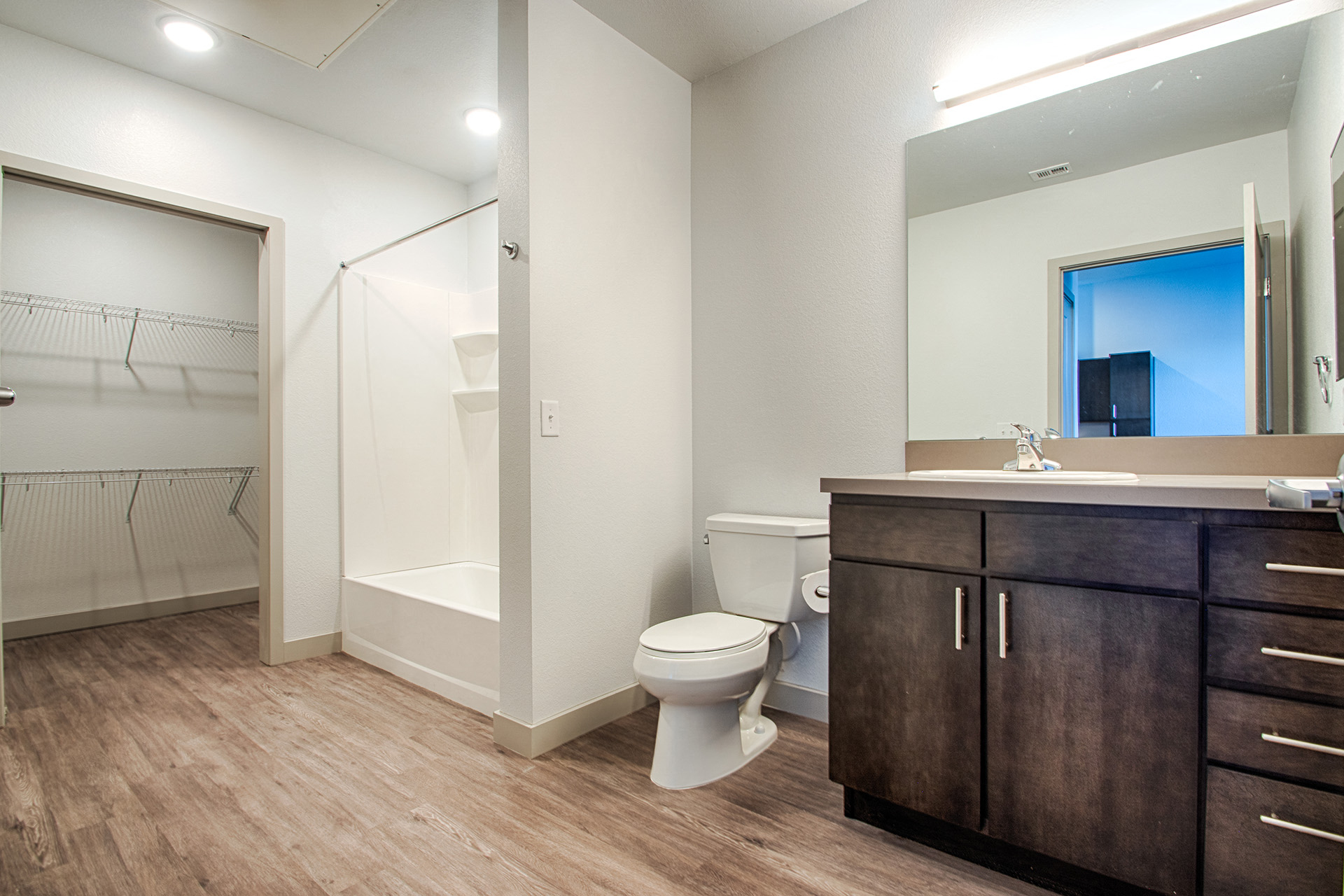 a bathroom with a toilet and a sink and a shower