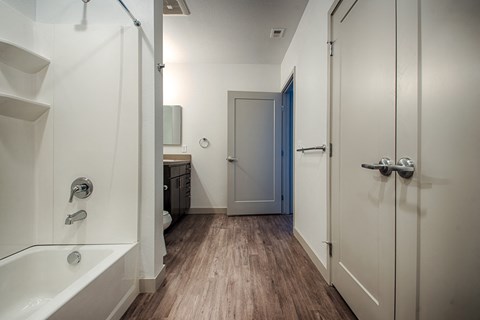 a bathroom with a shower and a sink and a bath tub