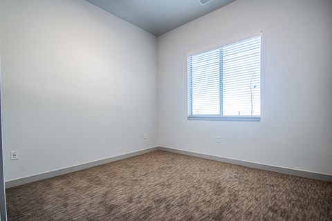 an empty room with white walls and a window