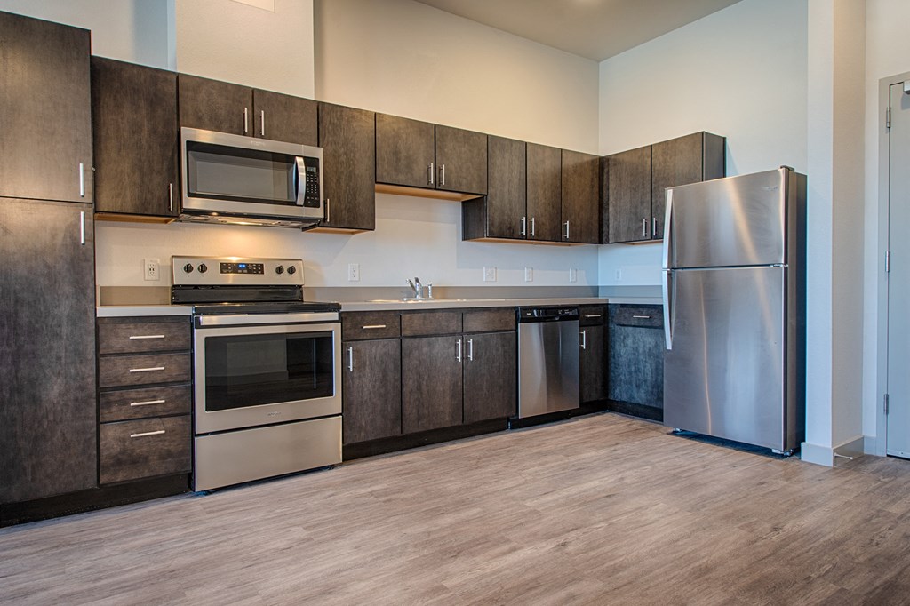 a kitchen with stainless steel appliances and wooden cabinets