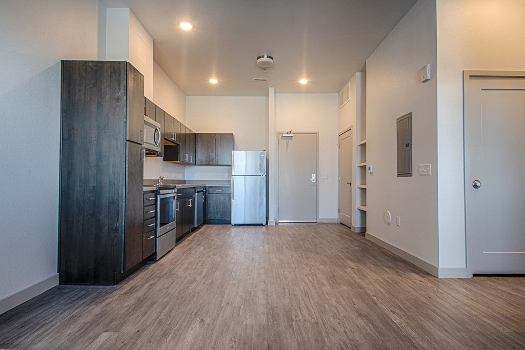 a kitchen with stainless steel appliances and a wood flooring
