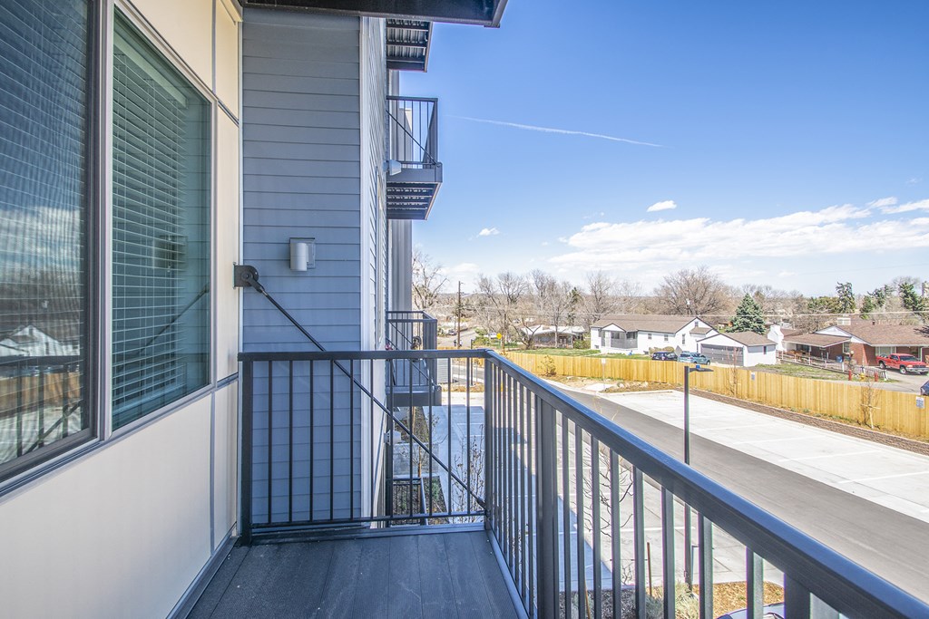 the view from the balcony of an apartment building with a balcony railing and a window