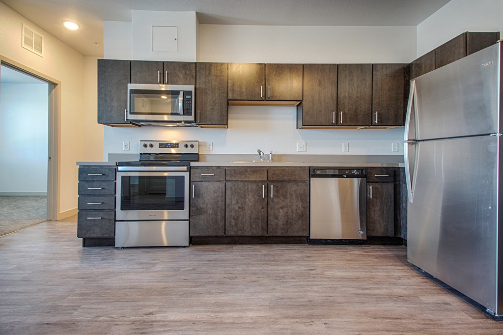 a kitchen with stainless steel appliances and wooden cabinets