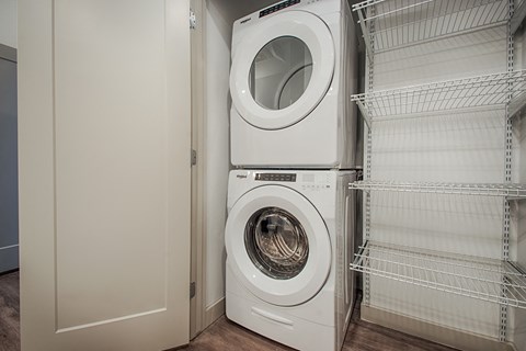 a front loading washer and dryer in a laundry room