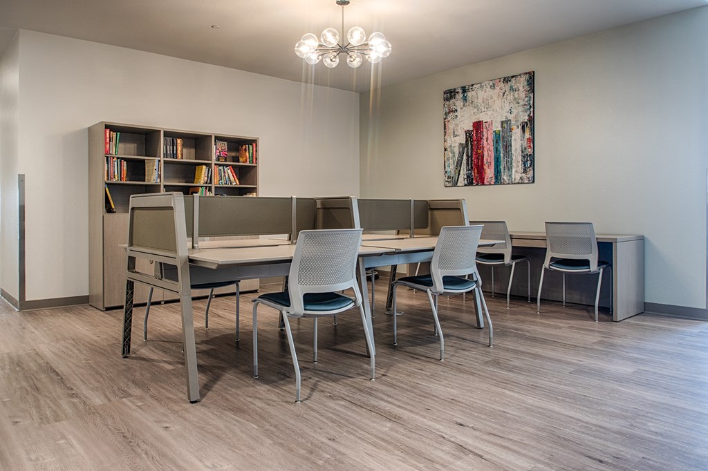 a dining room with a table and chairs and a bookshelf
