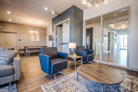 a living room with a table and chairs and a large mirror