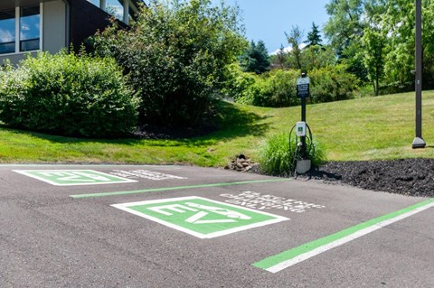 a parking lot in front of a building with parking meters