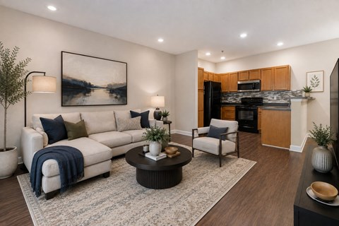 A modern living room with a large painting on the wall and a cozy seating area.