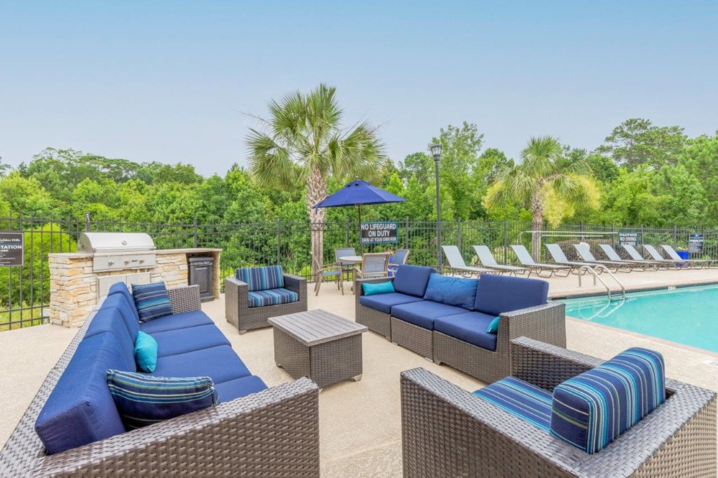 a swimming pool with lounge chairs and a poolside umbrella