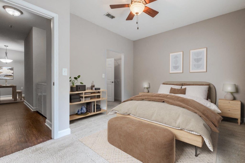 a bedroom with a bed and a ceiling fan