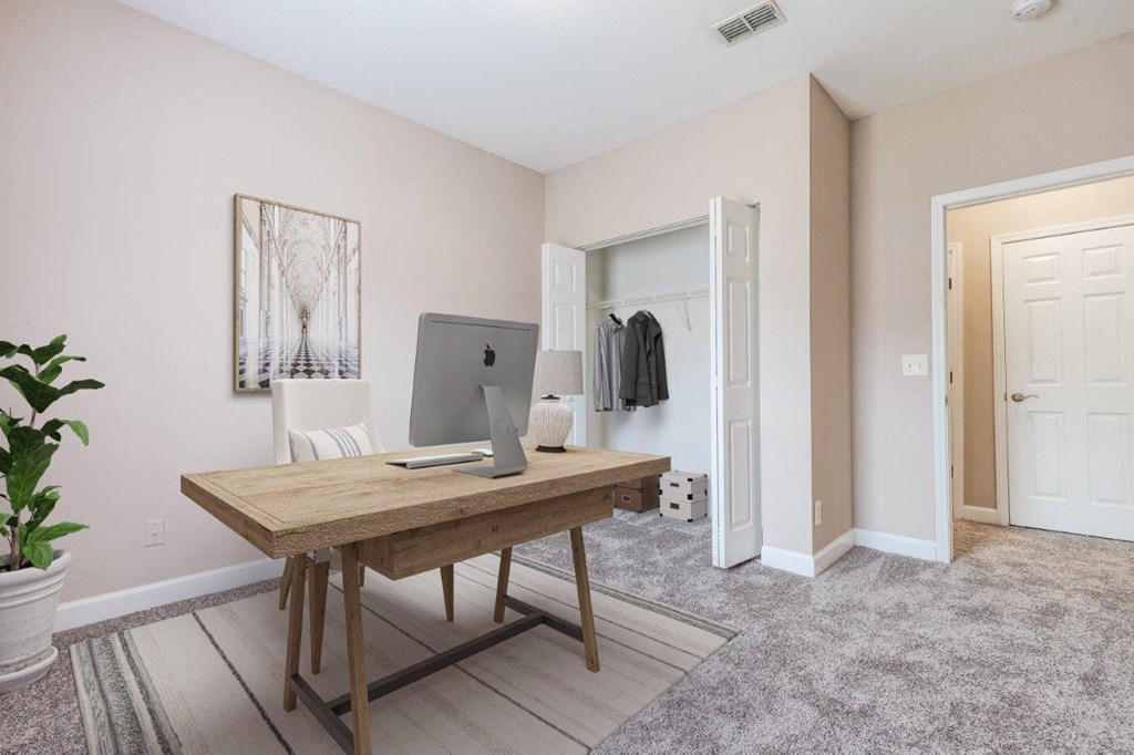 a home office with a desk with a computer