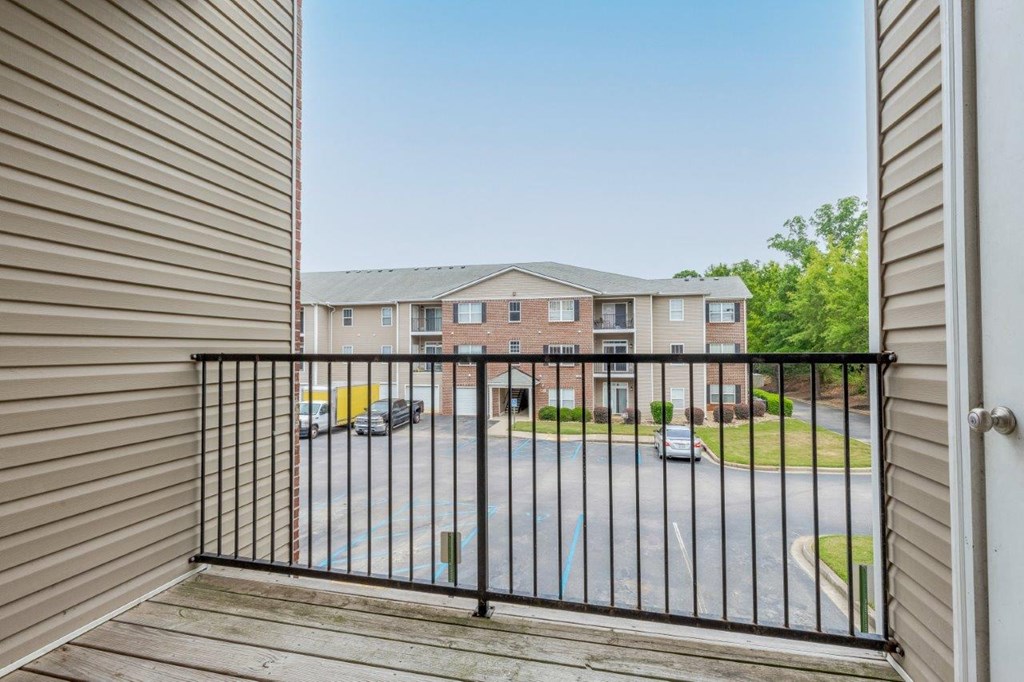 a balcony with a view of a building and a gate