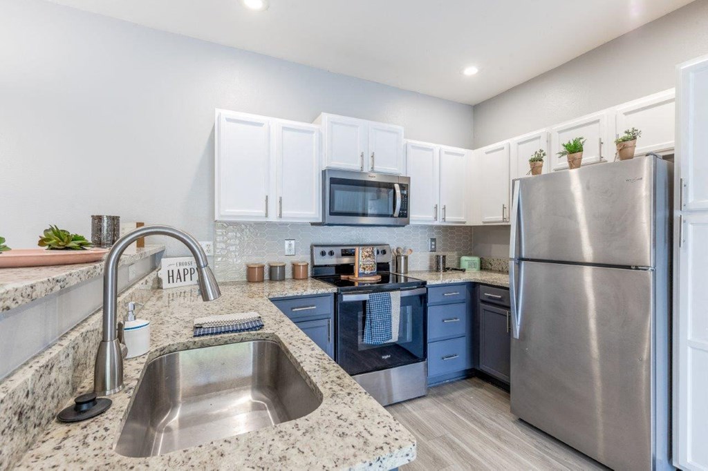 a kitchen with stainless steel appliances and granite counter tops