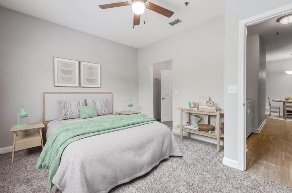 a bedroom with a bed and a ceiling fan