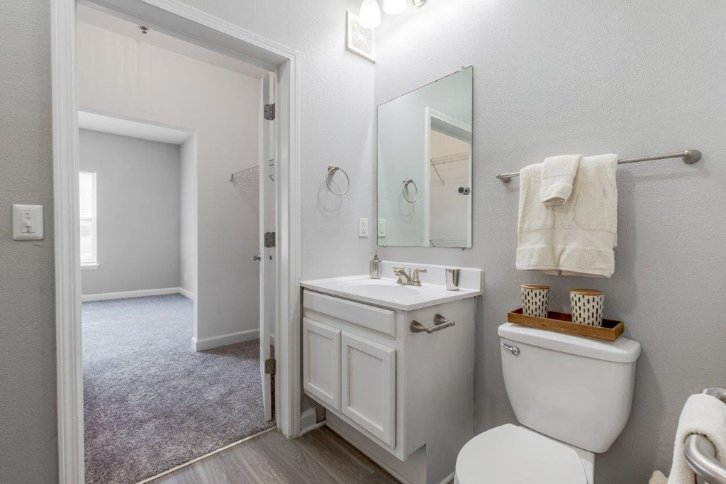 a white bathroom with a toilet and a sink