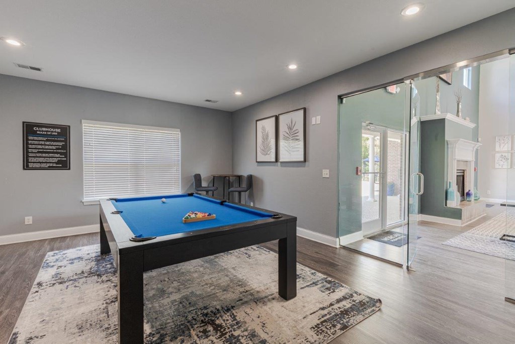 a games room with a pool table and a glass shower