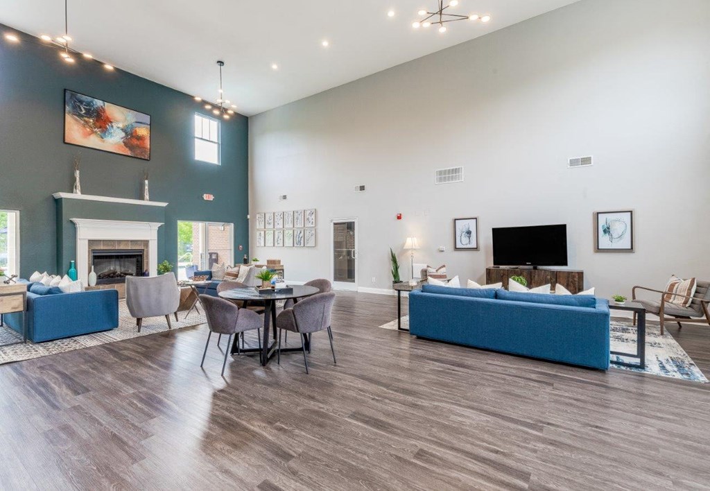 a living room with couches and a table and a fireplace