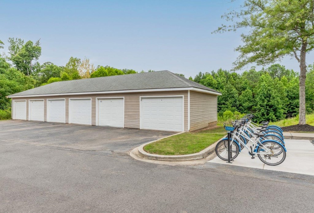 a row of bikes parked in front of a garage