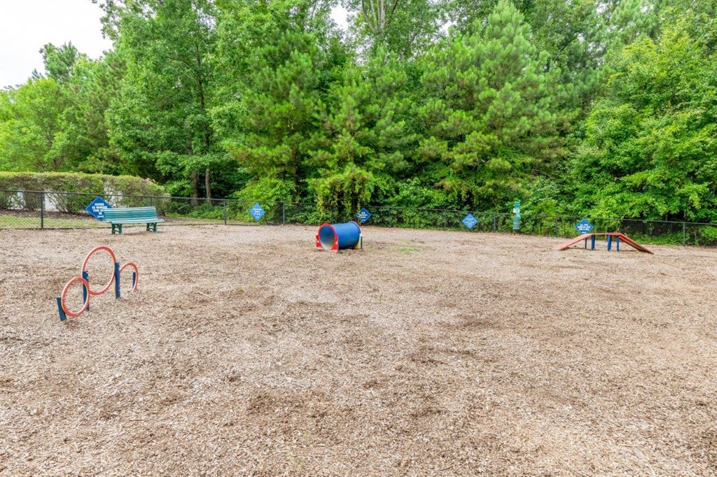 a park with playground equipment and trees in the background