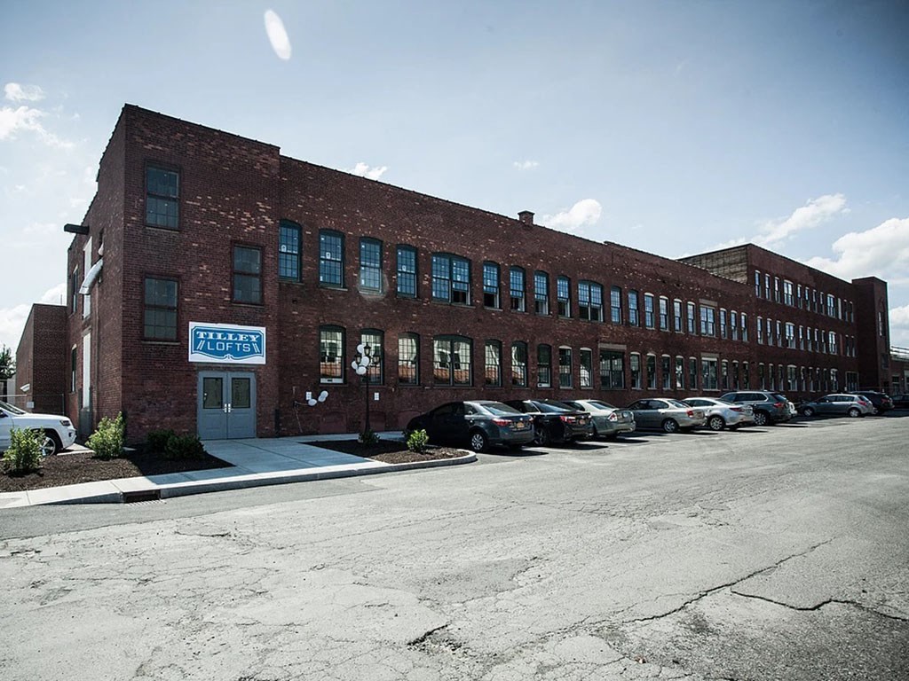 a large brick building with cars parked in front of it